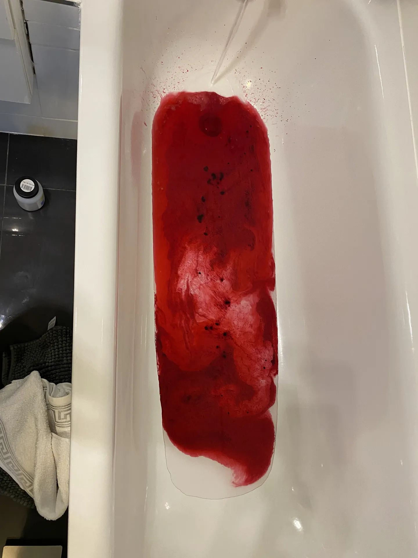 Red dye test in a bath to trace where water is escaping